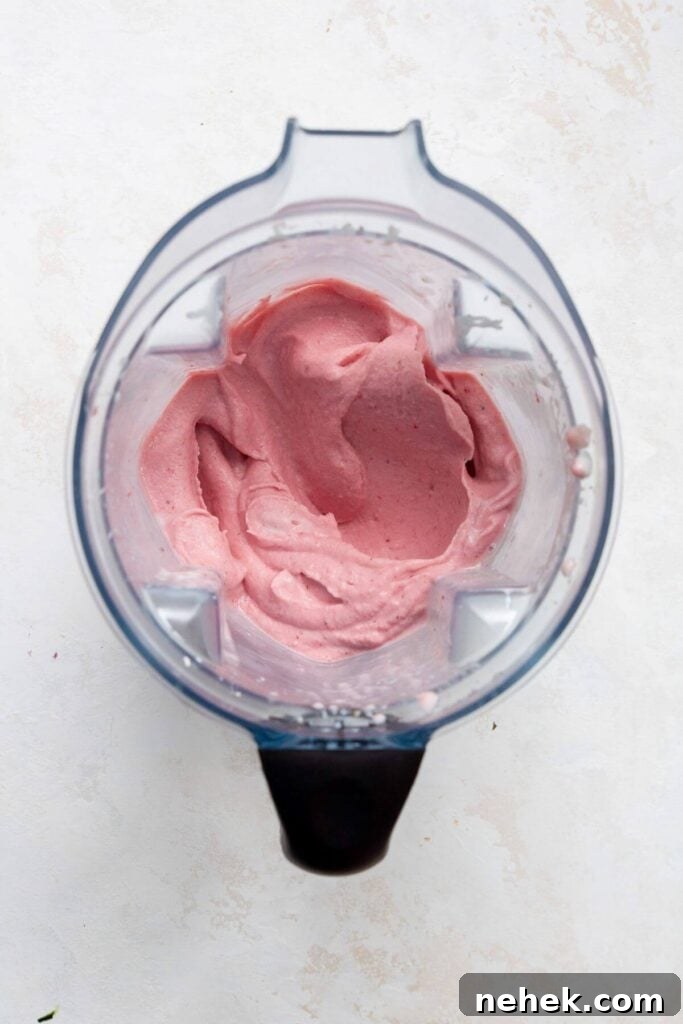 Creamy Strawberry Smoothie Bowl Recipe with Fresh Toppings 5 Thick and creamy strawberry smoothie blend inside a blender, ready to pour into a bowl