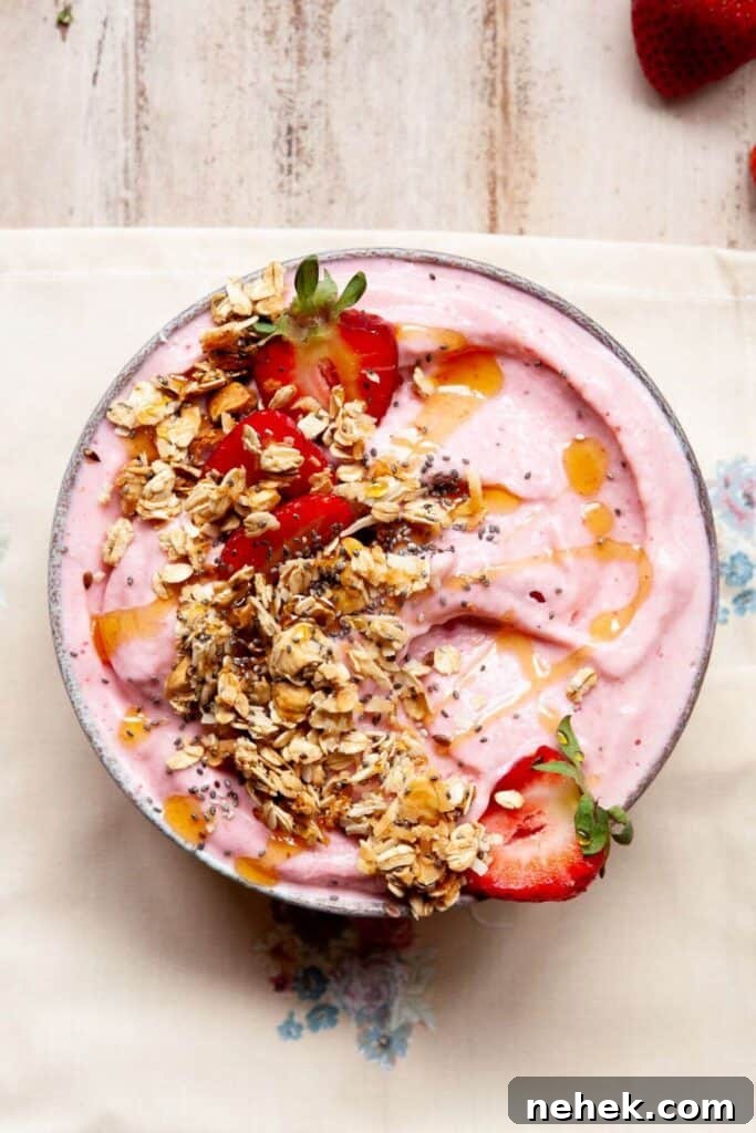 Creamy Strawberry Smoothie Bowl Recipe with Fresh Toppings 6 healthy strawberry smoothie bowl topped with crunchy granola and a drizzle of honey