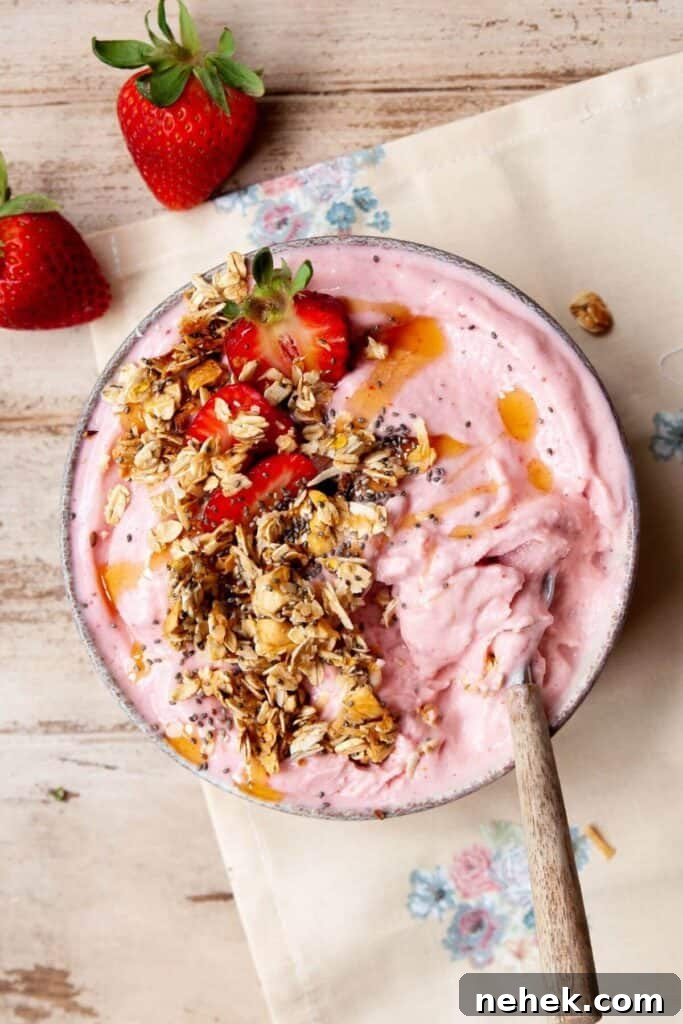 Creamy Strawberry Smoothie Bowl Recipe with Fresh Toppings 8 Creamy strawberry smoothie bowl topped with granola, chia seeds, honey drizzle, and fresh strawberries