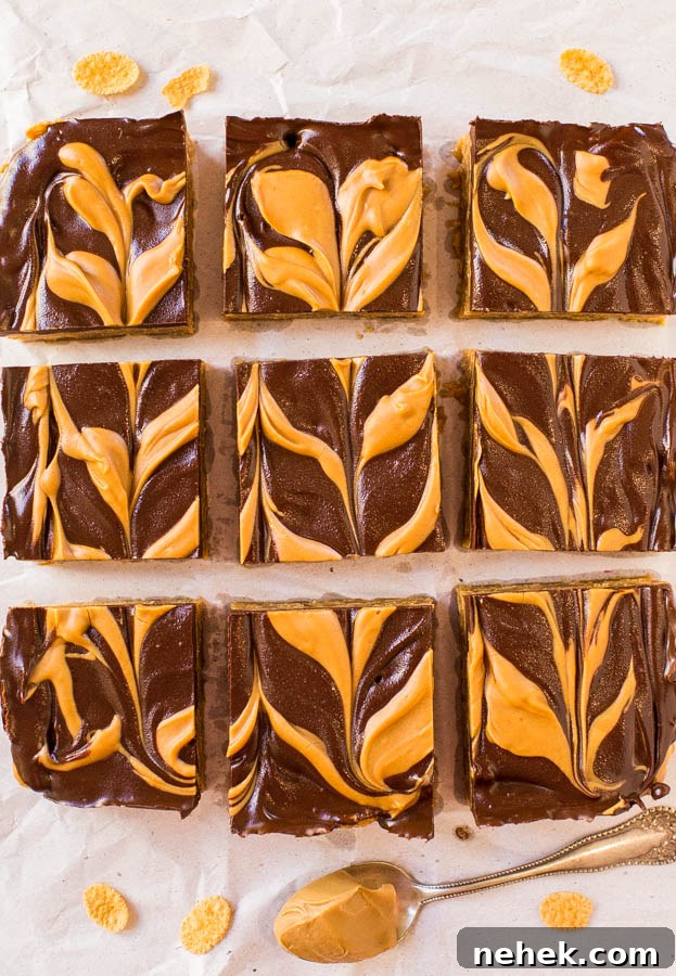 Slices of peanut butter swirl brownies arranged on parchment paper.
