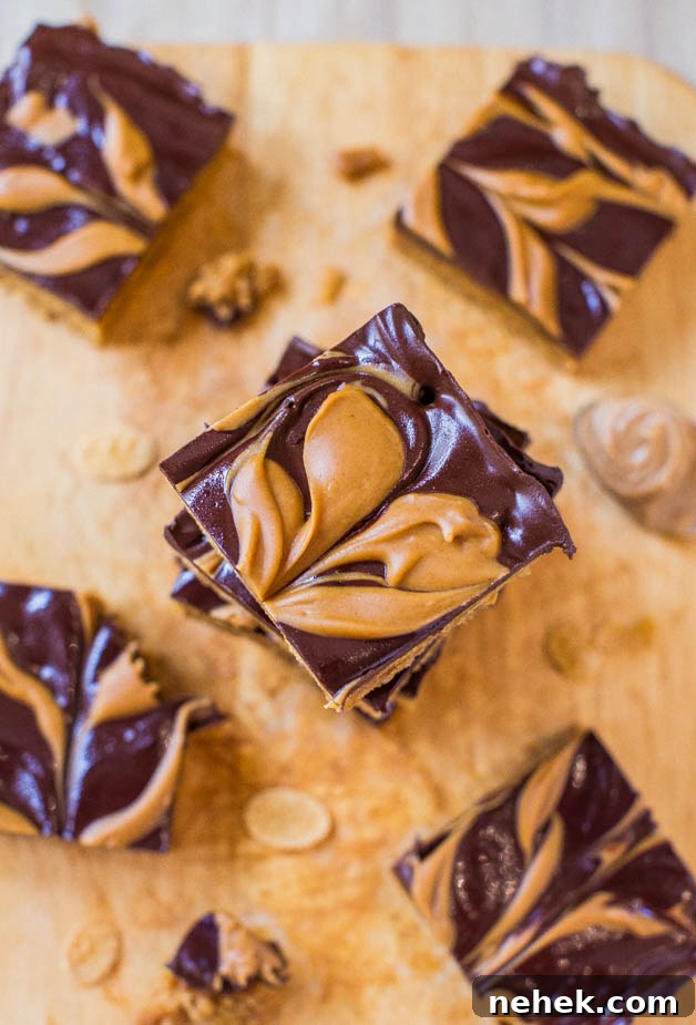Chocolate and peanut butter swirl brownies on a wooden cutting board.