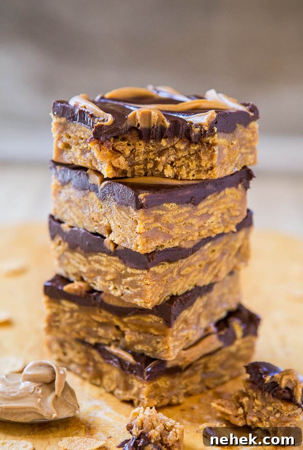 A stack of peanut butter chocolate bars on a wooden surface.