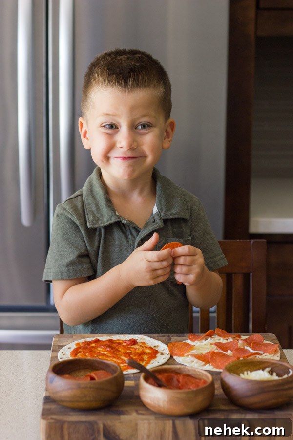 Waffled Pizza Pocket ingredients on a cutting board with a little boy assembling his pizza.