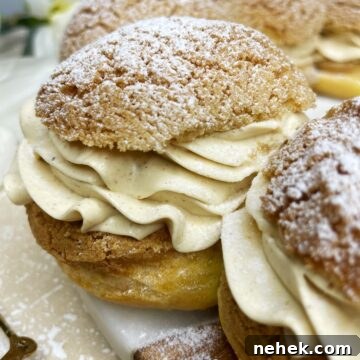 Paris-Brest dessert filled with praline mousseline cream and dusted with icing sugar.