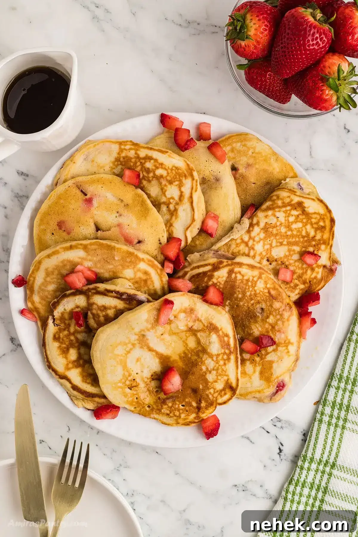 An overhead image of pancakes on a serving platter.