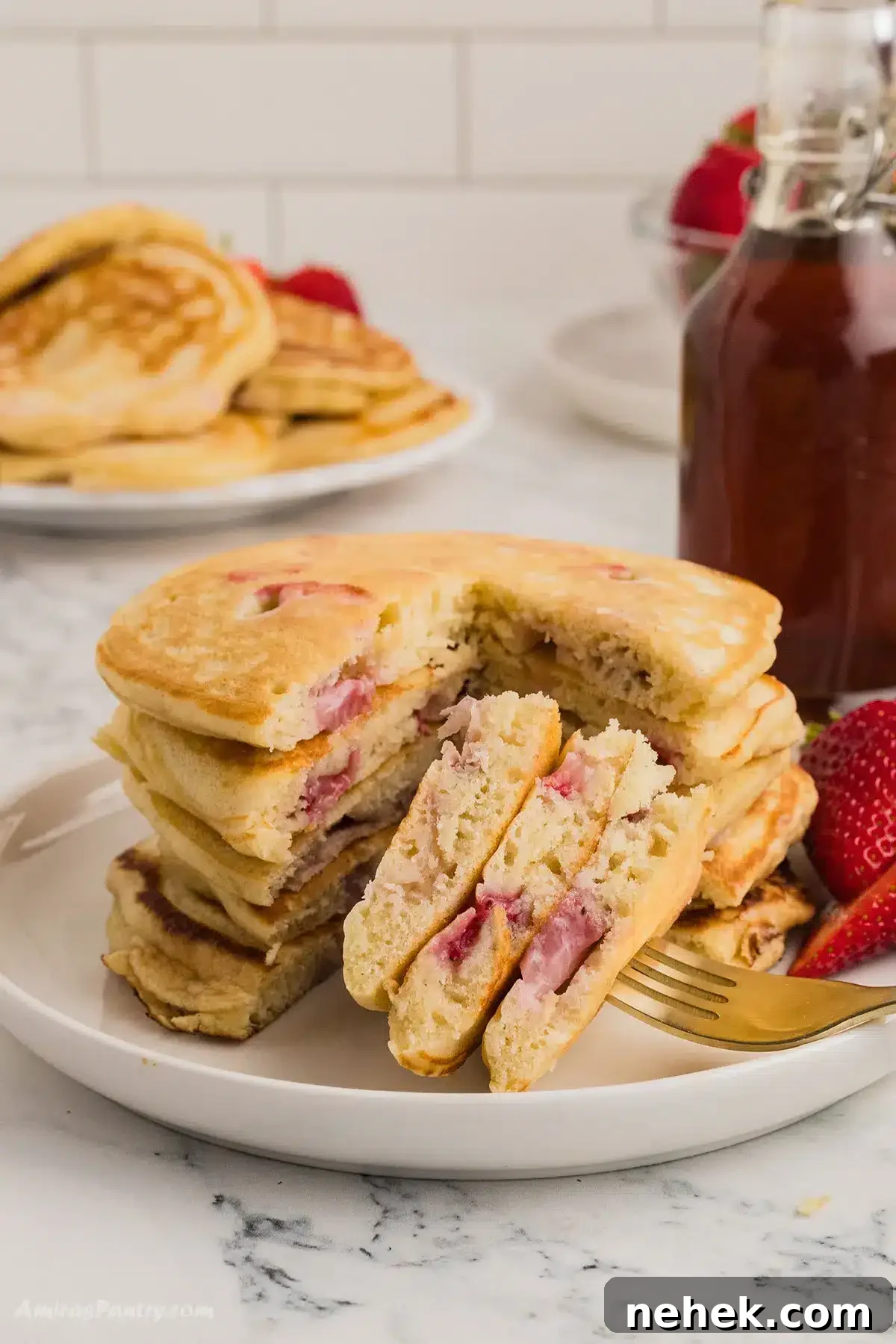A stack of pancakes with a quarter cut to show texture.