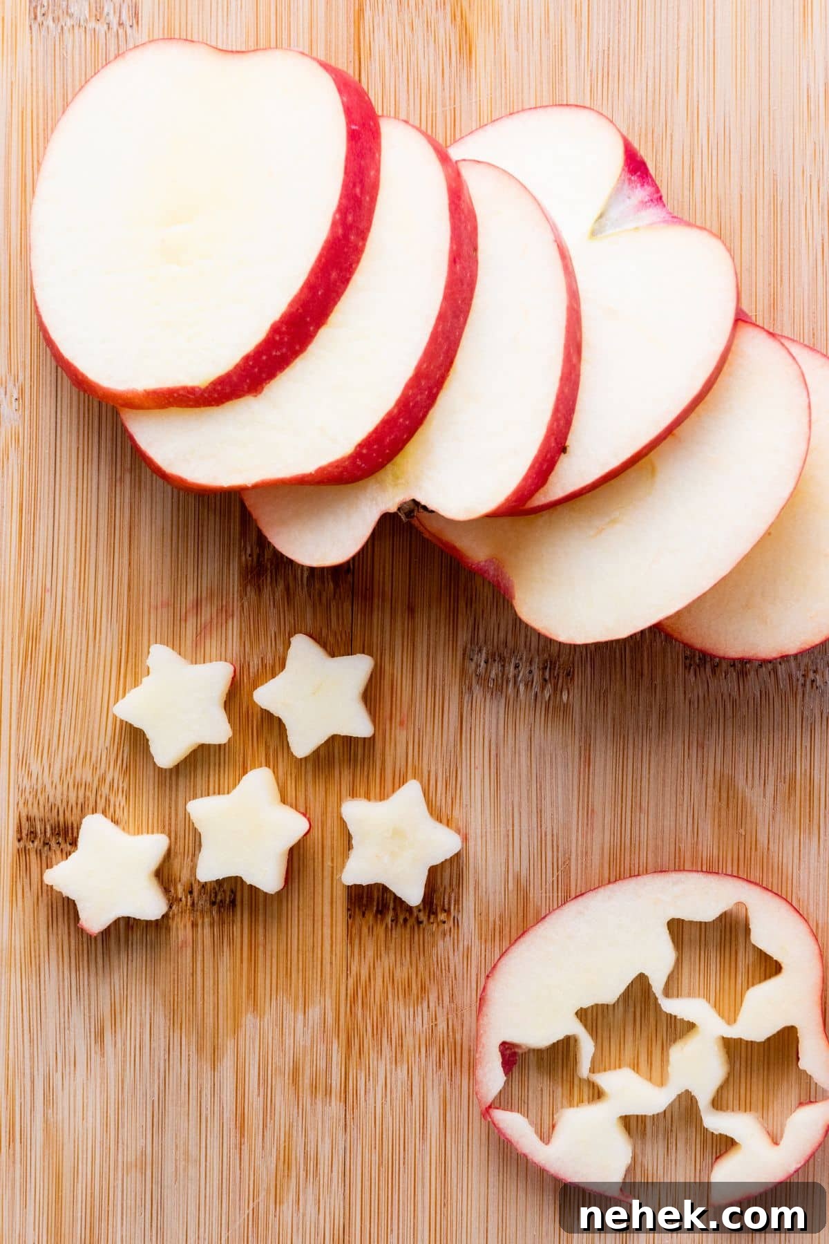 Cutting out star shapes from apple slices.