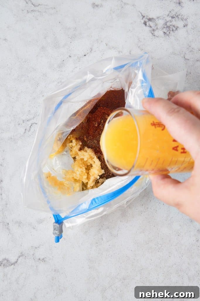 Adding fresh orange juice into a resealable bag with spices