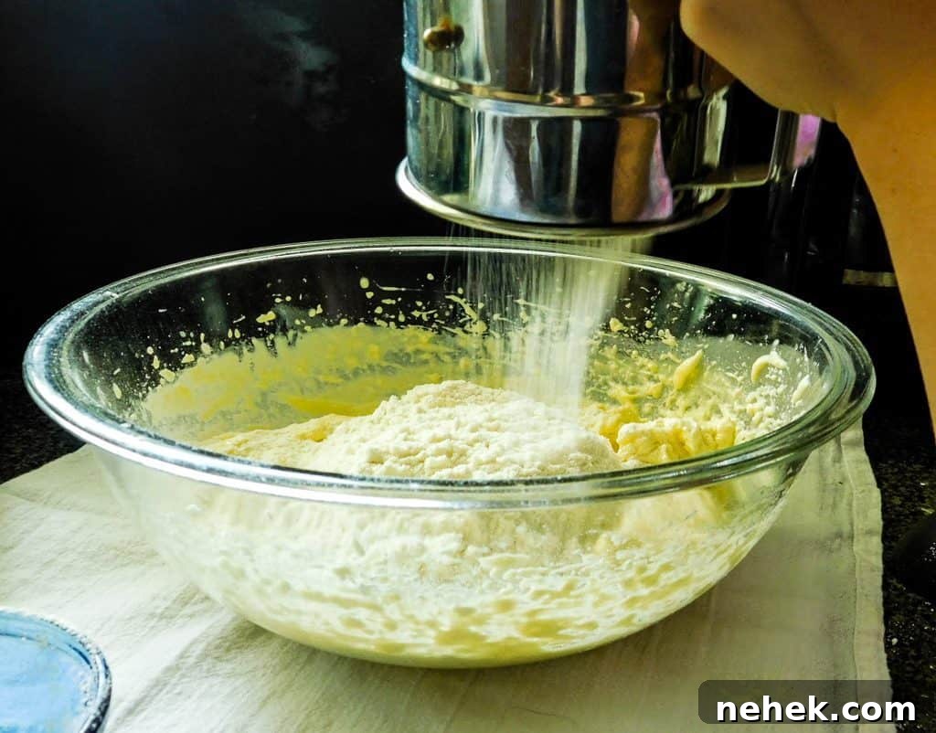 sifting ingredients for low carb bread into a glass bowl.