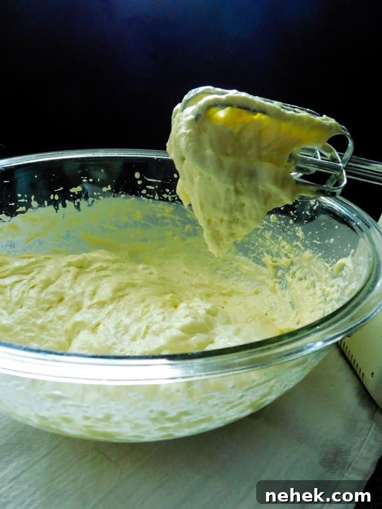 low carb bead batter stuck to a beater in a glass bowl.