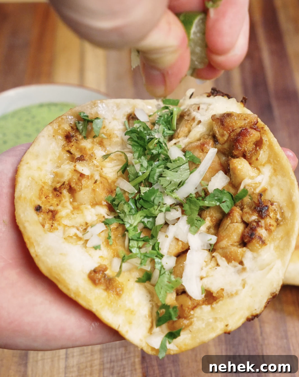 Fresh chopped cilantro and finely diced onion added on top of crispy chicken tacos, finished with a squeeze of lime for brightness and flavor.
