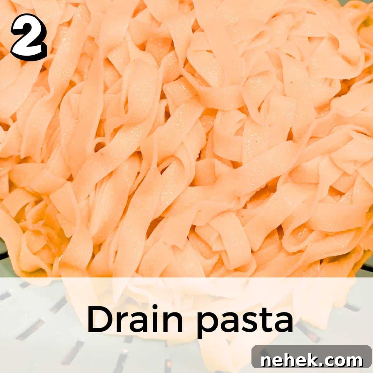 The noodles draining in a blue colander in a sink.