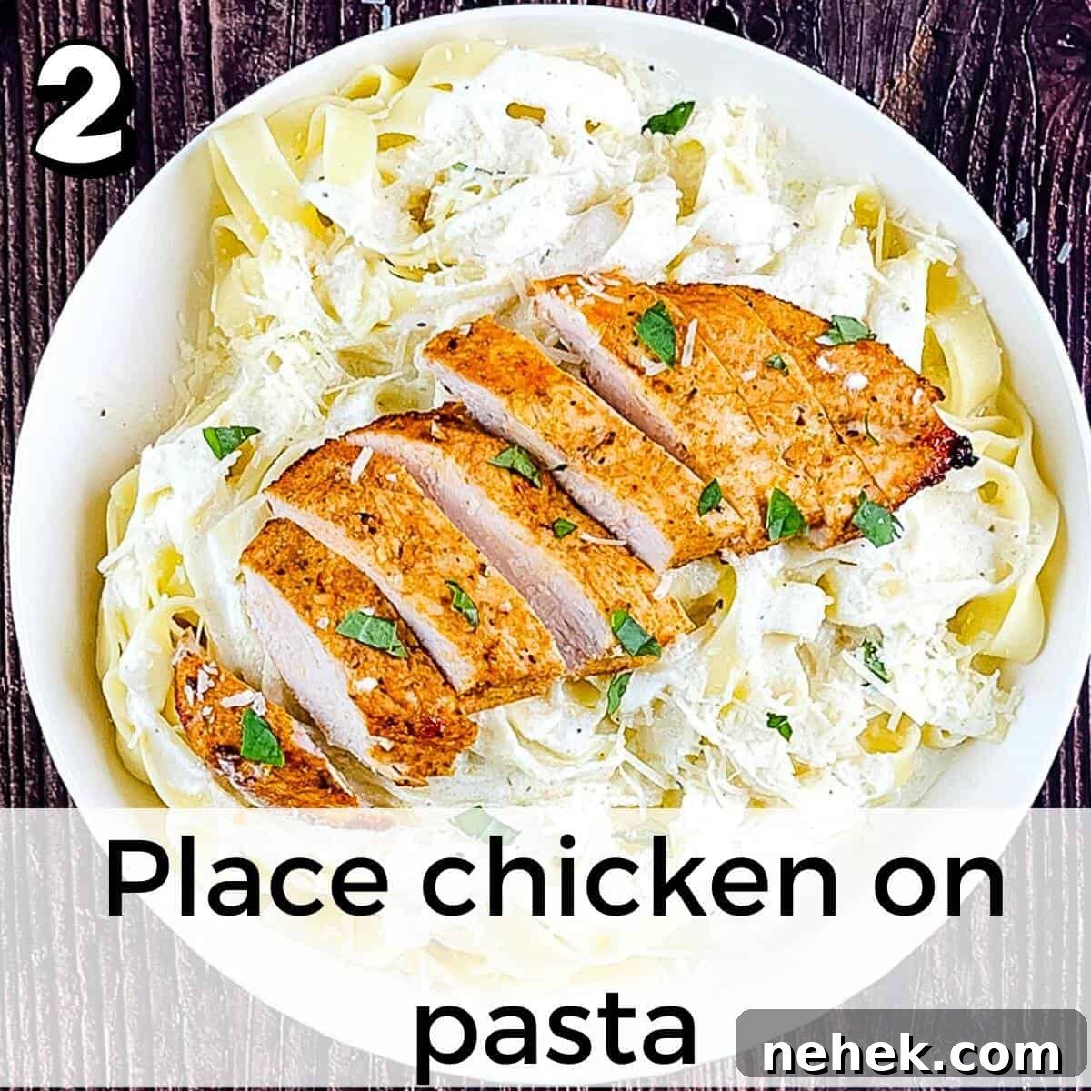 The chicken breast placed on top of fettuccine noodles tossed with homemade alfredo sauce.