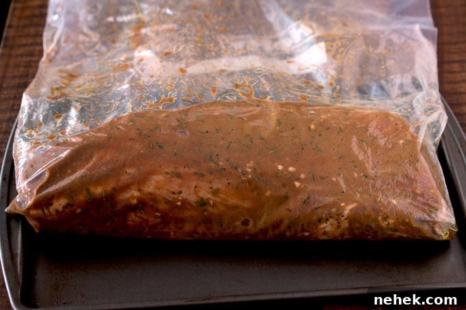 Pictured here a resealable bag with a pork loin and marinade inside