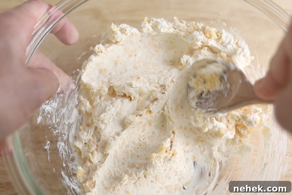 Mixing cheese filling mixture for jalapeno poppers.
