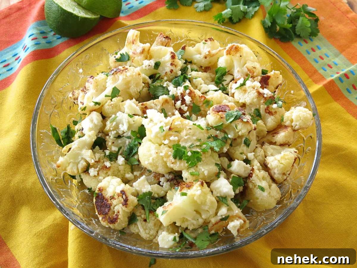 Glass bowl with street style cauliflower on a yellow napkin.