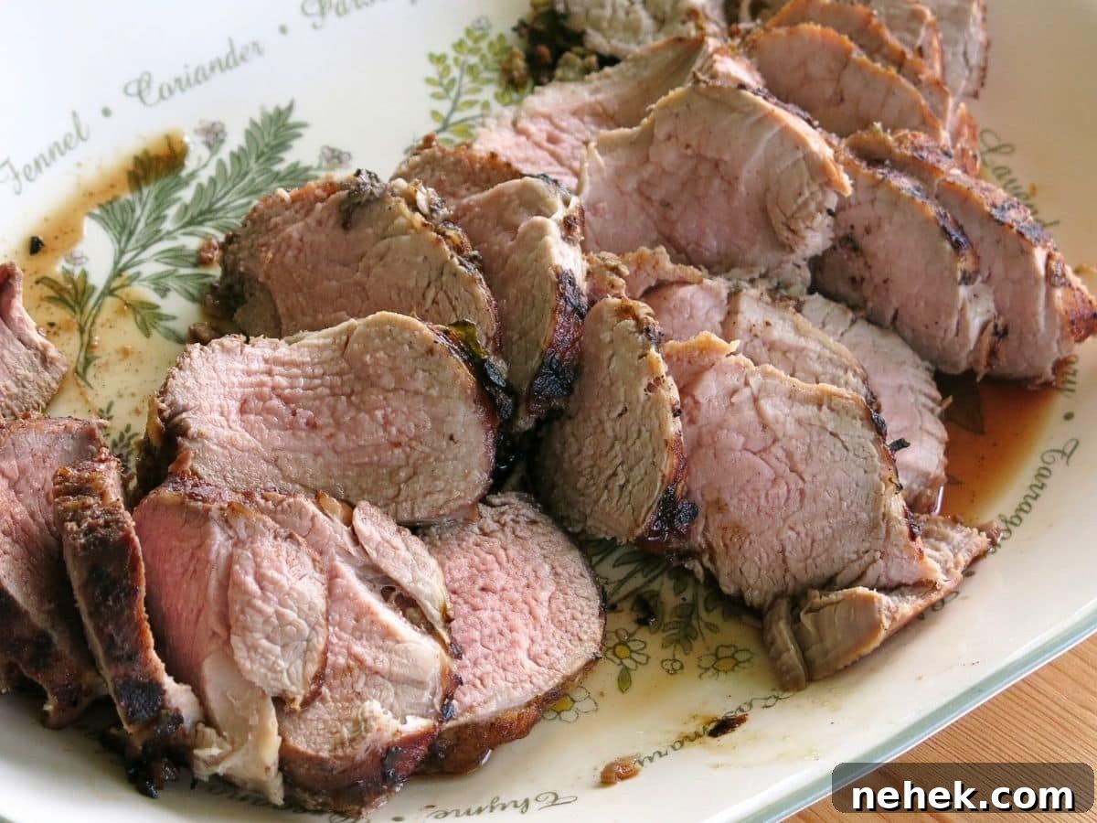 Platter of cooked and sliced pork tenderloin.