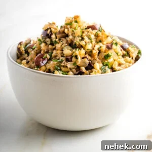 Mediterranean Cauliflower Rice Recipe with Sun‑Dried Tomatoes & Olives 15 Cauliflower rice with olives, pine nuts and parsley in a white bowl.