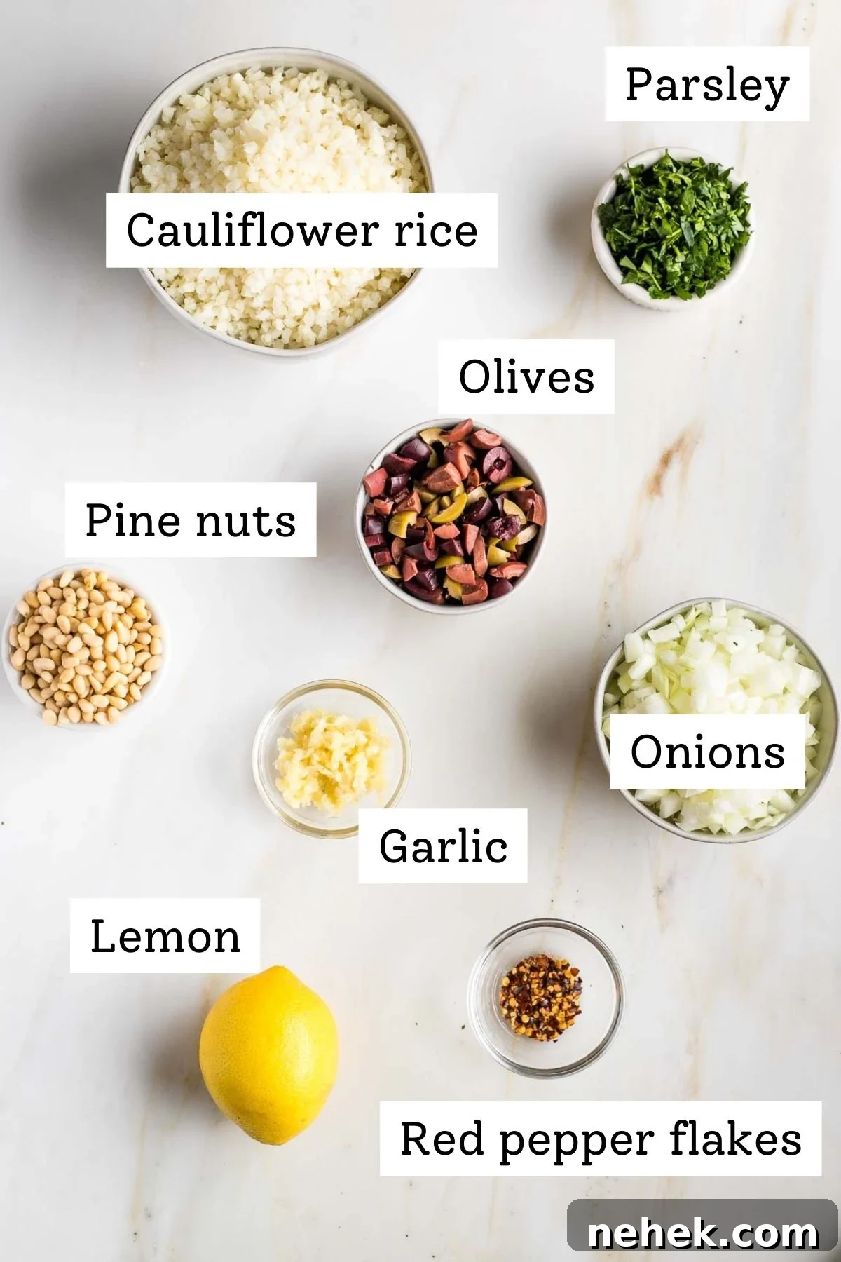 Mediterranean Cauliflower Rice Recipe with Sun‑Dried Tomatoes & Olives 3 Labeled ingredients: cauliflower rice, fresh parsley, olives, pine nuts, onions, garlic, lemon, red pepper flakes.