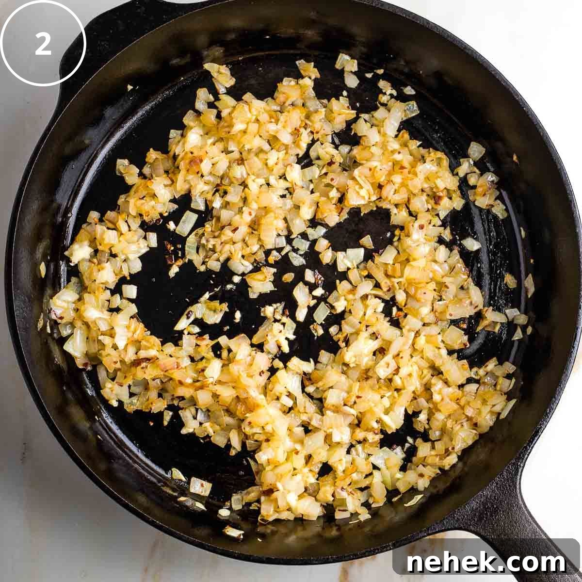 Mediterranean Cauliflower Rice Recipe with Sun‑Dried Tomatoes & Olives 5 Step 2: Browned onions in a cast iron skillet.