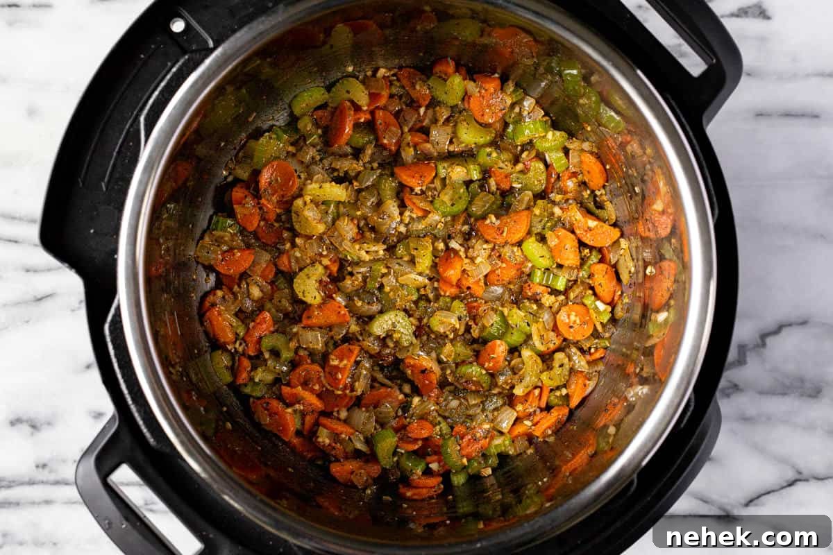 Creamy Instant Pot Broccoli Cheddar Soup Recipe 4 Instant pot filled with sauteed veggies.