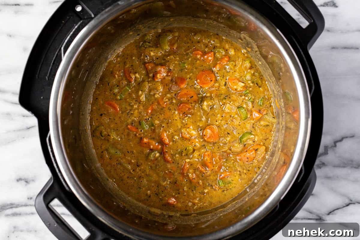 Creamy Instant Pot Broccoli Cheddar Soup Recipe 5 Instant pot filled with sauteed veggies in a creamy sauce.