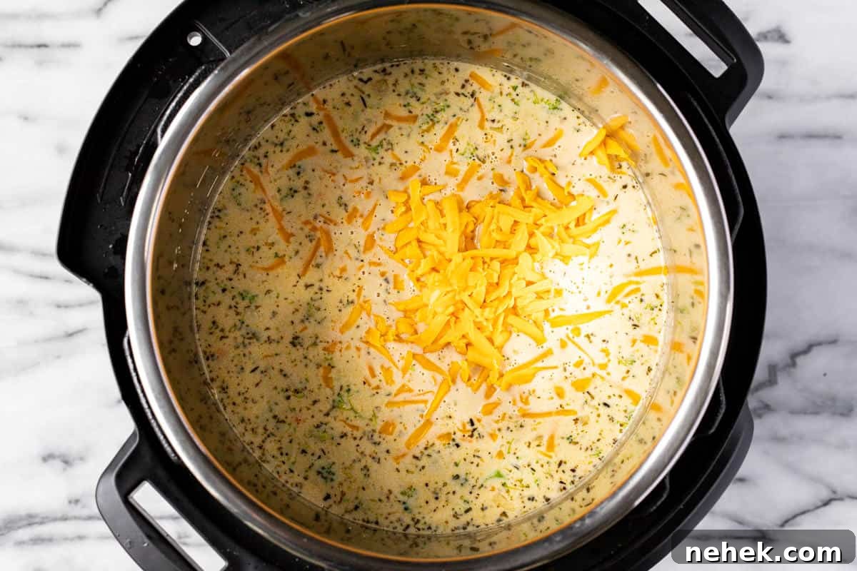 Creamy Instant Pot Broccoli Cheddar Soup Recipe 7 Instant pot filled with ingredients to make broccoli cheddar soup.