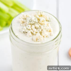 Blue cheese dressing with blue cheese crumble in a mason jar.