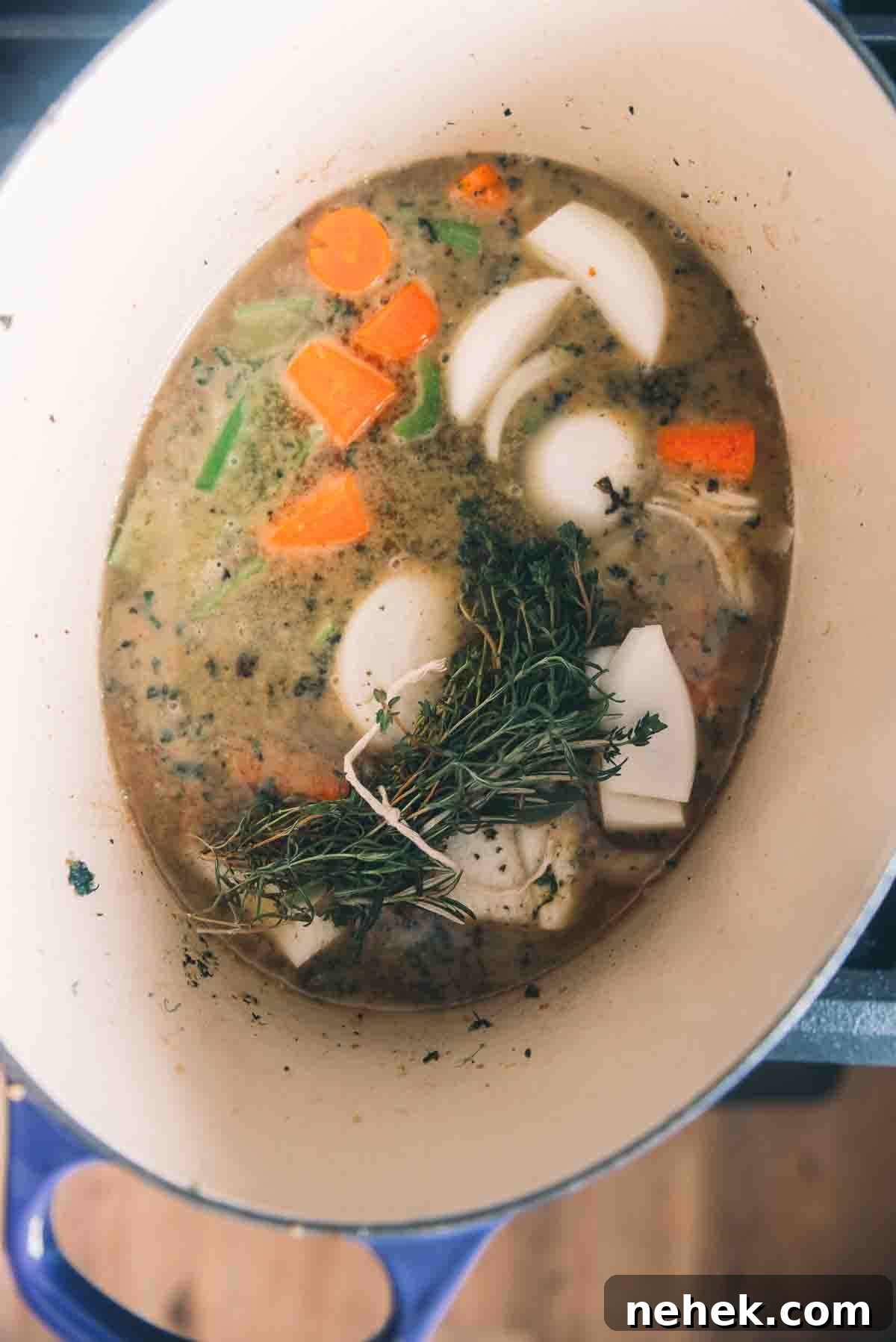 Vegetables and herbs added to the pot. 