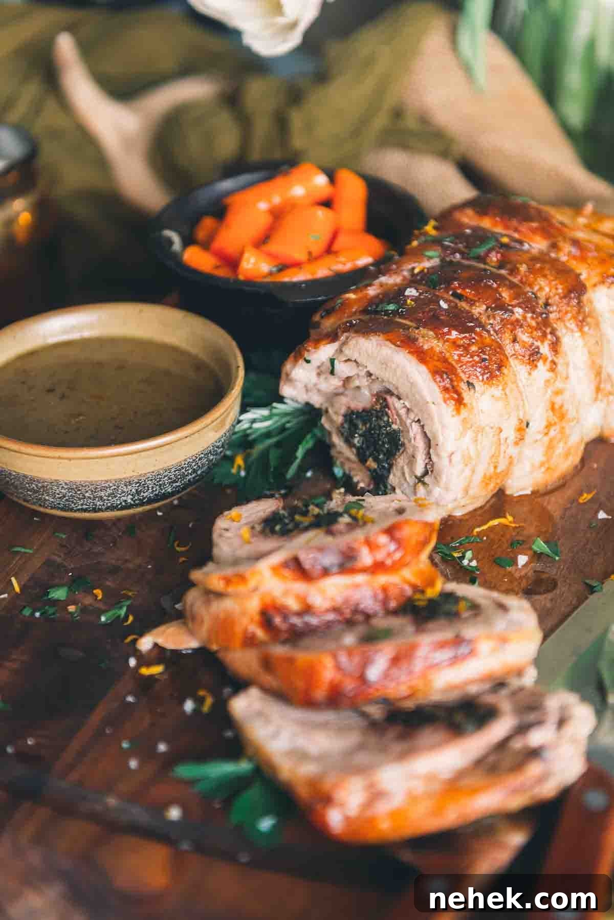 Golden brown rolled veal roast thats sliced for serving. 