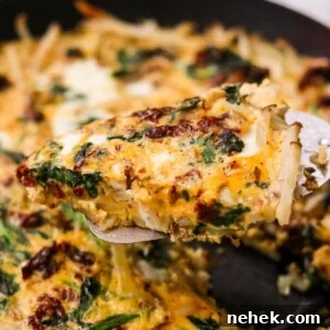 Dairy free veggie frittata slice lifted with a spatula.