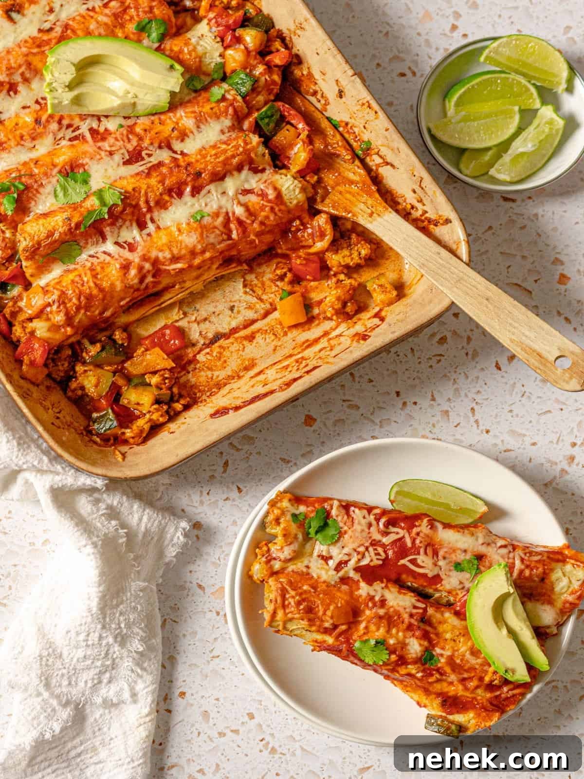two ground turkey enchiladas on a plate removed from the casserole dish