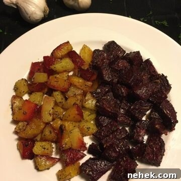 Herb Garlic Roasted Beets on white plate with 2 heads of garlic in the background