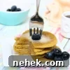 35 High-Protein Vegan Powder Recipes for Smoothies & Snacks 15 Stack of protein pancakes with blueberries and butter on top.