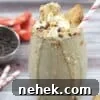 35 High-Protein Vegan Powder Recipes for Smoothies & Snacks 26 Glass with cookies and cream shake topped with coconut whipped cream.