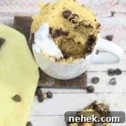 35 High-Protein Vegan Powder Recipes for Smoothies & Snacks 9 Chocolate chip mug cake with coconut cream in a white mug.