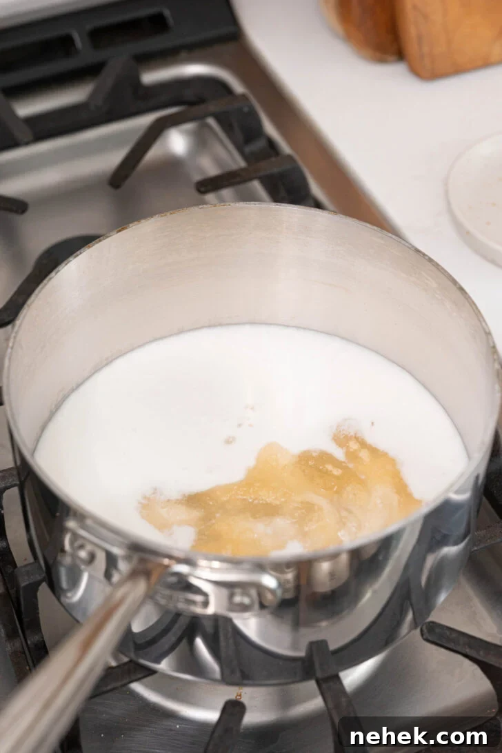 Coconut milk with bloomed gelatin in a pot.