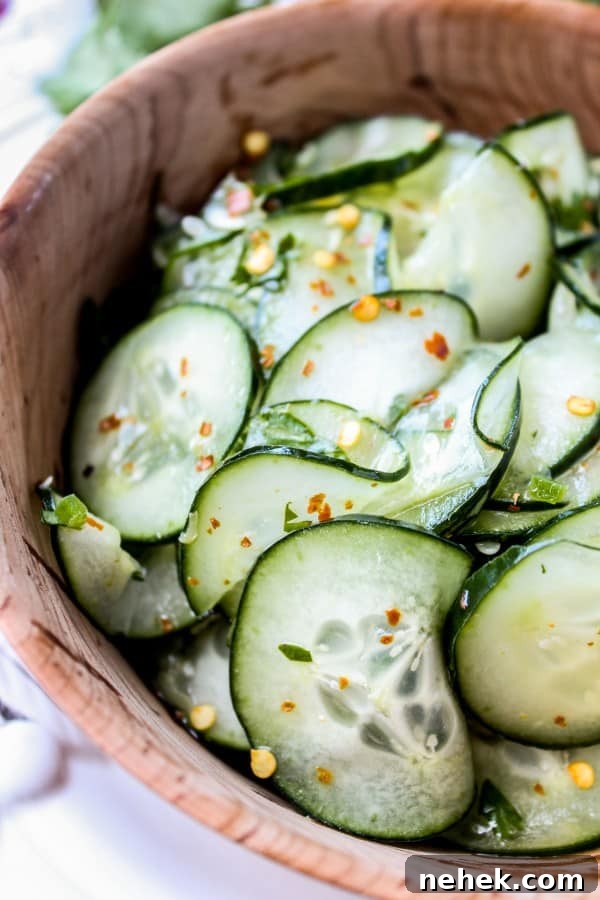 Cilantro Lime Cucumber Salad Mexican cucumber salad with cilantro and lime in a wooden salad bowl.