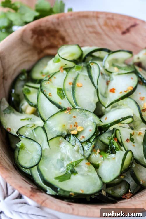 Cilantro Lime Cucumber Salad Mexican cucumber salad with cilantro and lime in a wooden salad bowl.