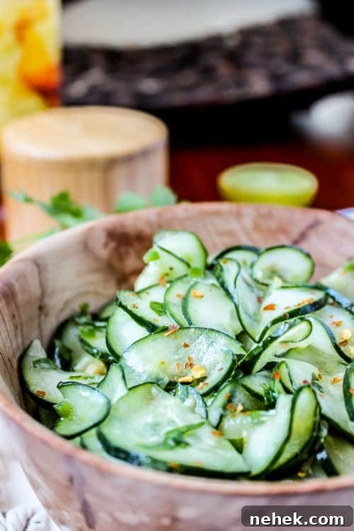 Cilantro Lime Cucumber Salad Mexican cucumber salad with cilantro and lime in a wooden salad bowl.