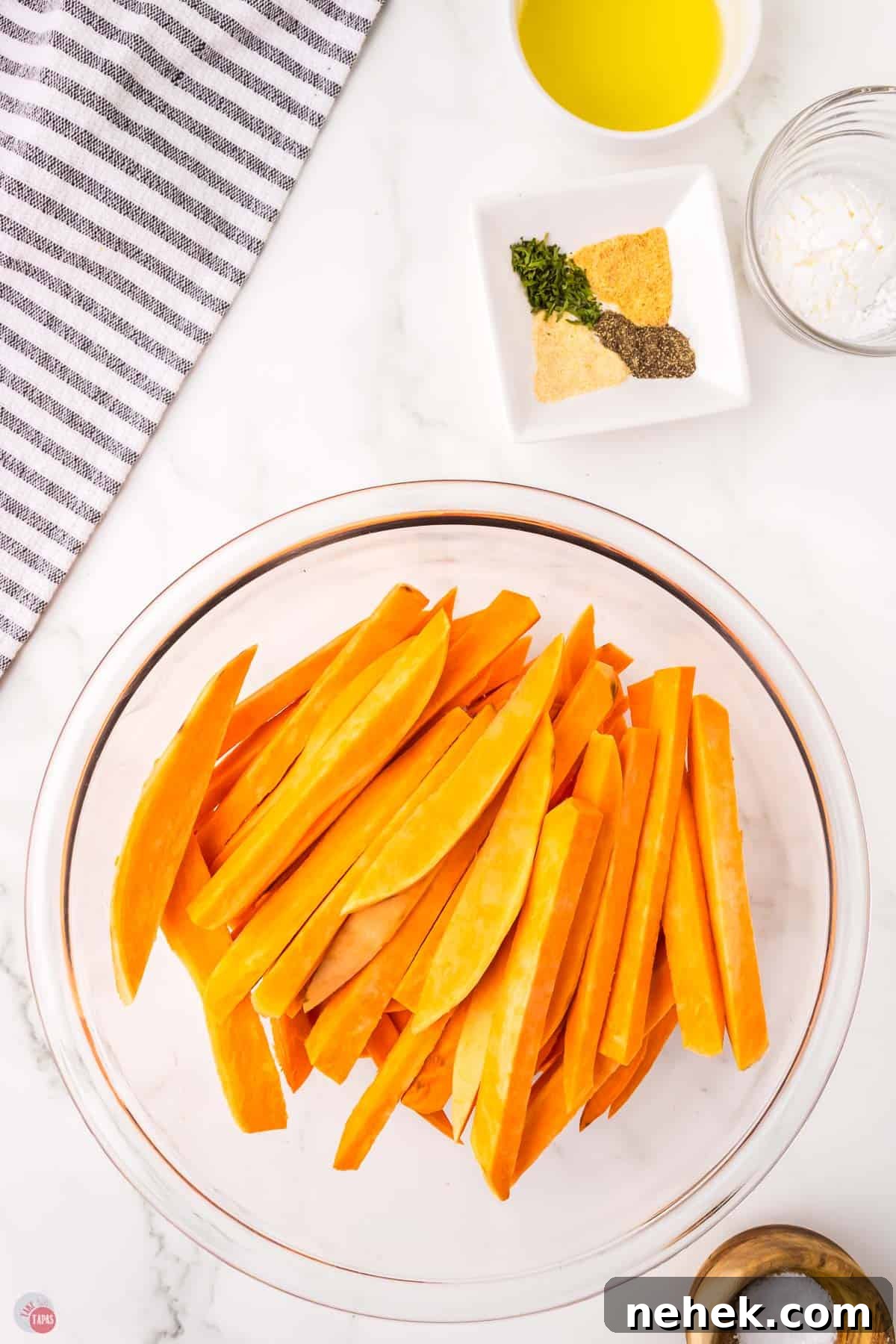 Crispy Oven-Baked Sweet Potato Fries Recipe 4 sweet potatoes cut into strips and placed in a bowl