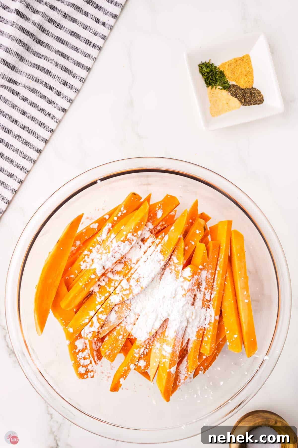 Crispy Oven-Baked Sweet Potato Fries Recipe 5 sweet potato strips in a bowl with cornstarch