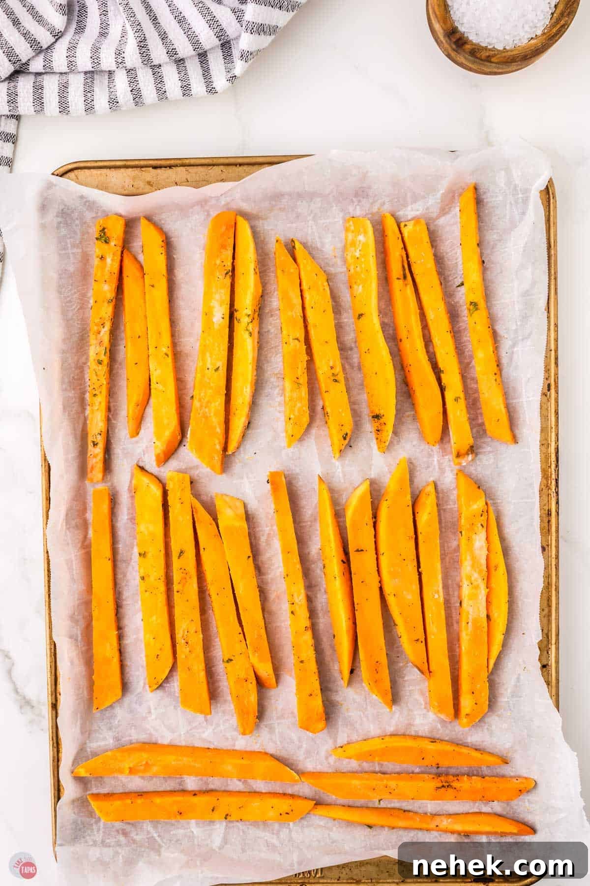 Crispy Oven-Baked Sweet Potato Fries Recipe 7 fries on a baking sheet