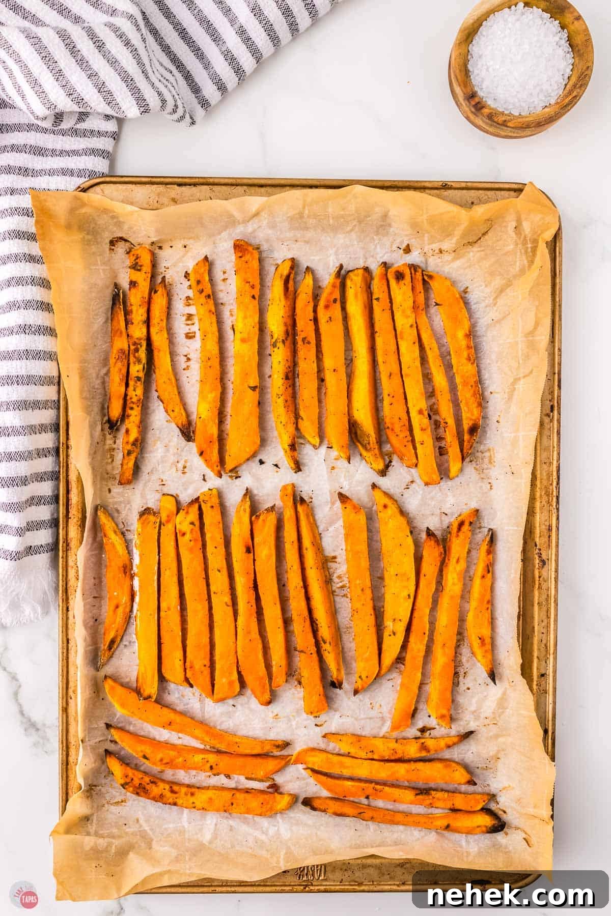 Crispy Oven-Baked Sweet Potato Fries Recipe 8 baking sheet with parchment and fries
