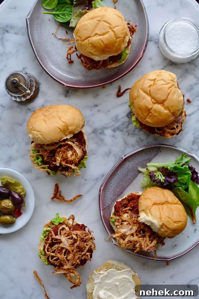 These chorizo burgers are made with Mexican chorizo and ground beef then topped with smashed avocado and a generous pile of crispy fried red onion strings. chorizo burgers with crispy onions recipe