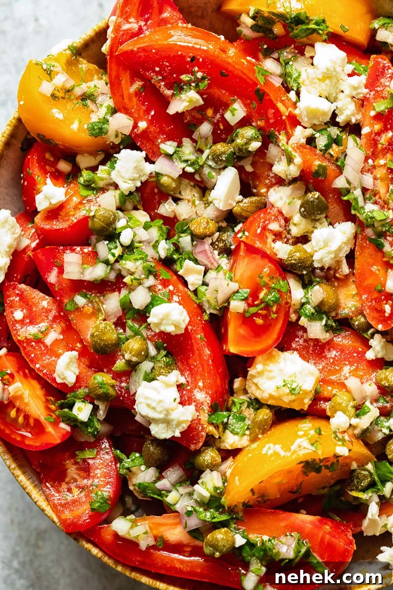close up of tomato salad with herbs and feta