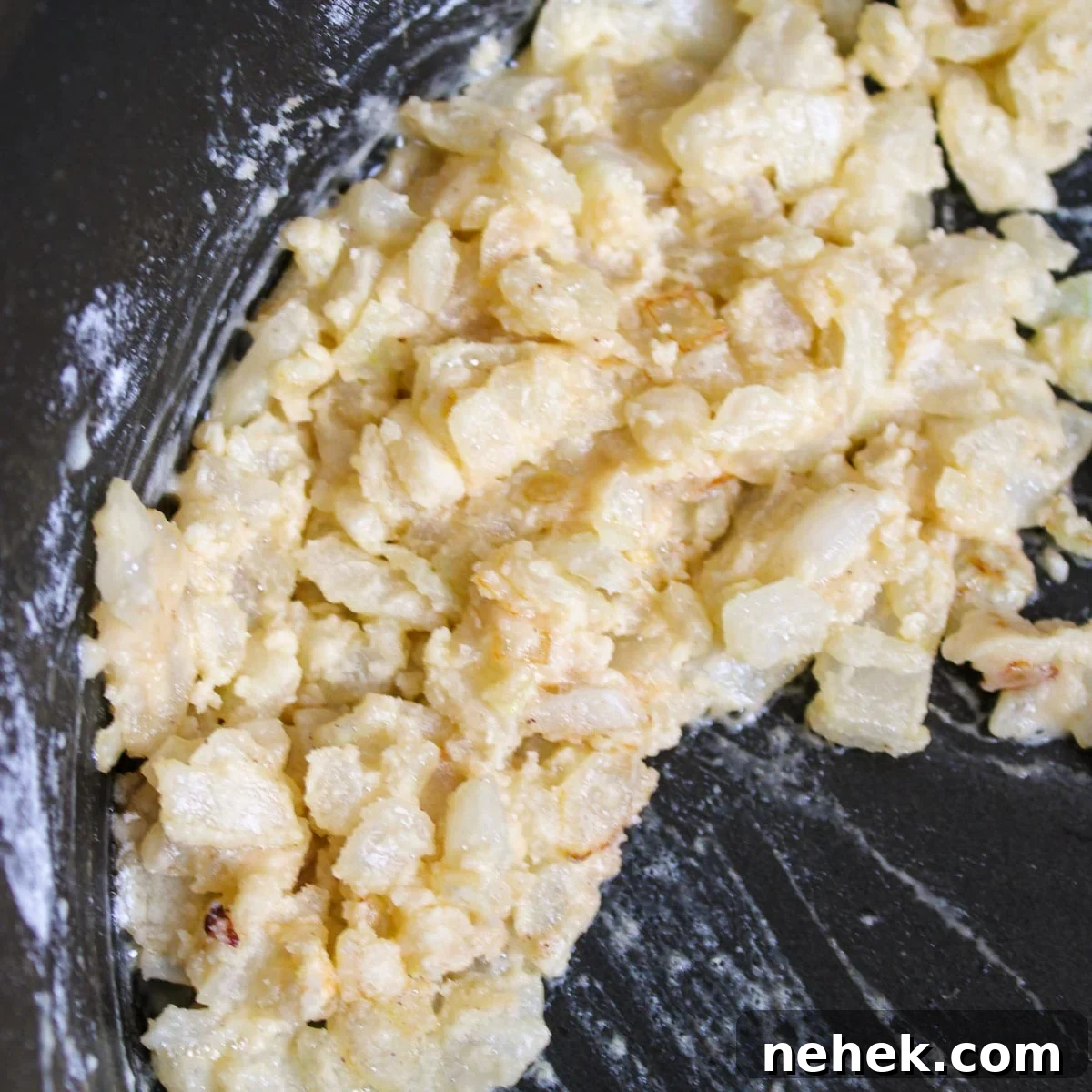 Making a roux with butter, onion, and flour.