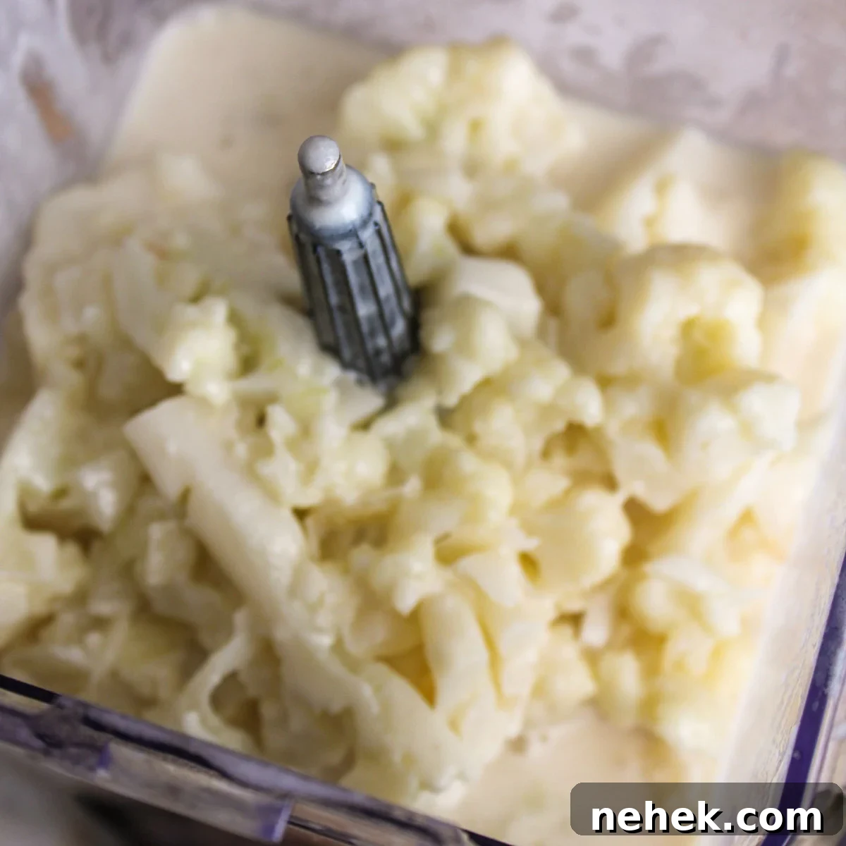 Blending the softened cauliflower and liquid in the blender.