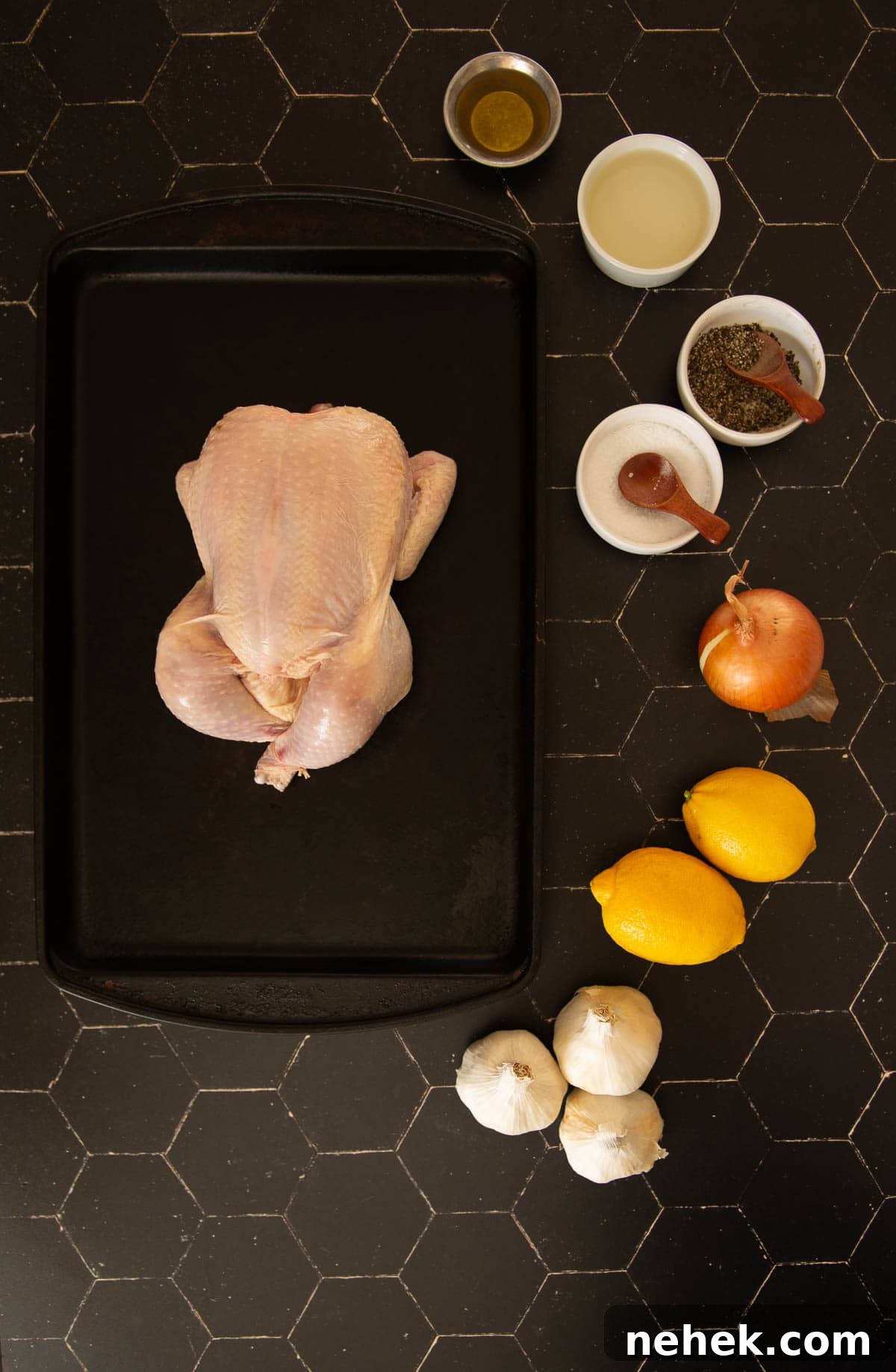 A chicken on a cutting board with lemons and other ingredients for this recipe.