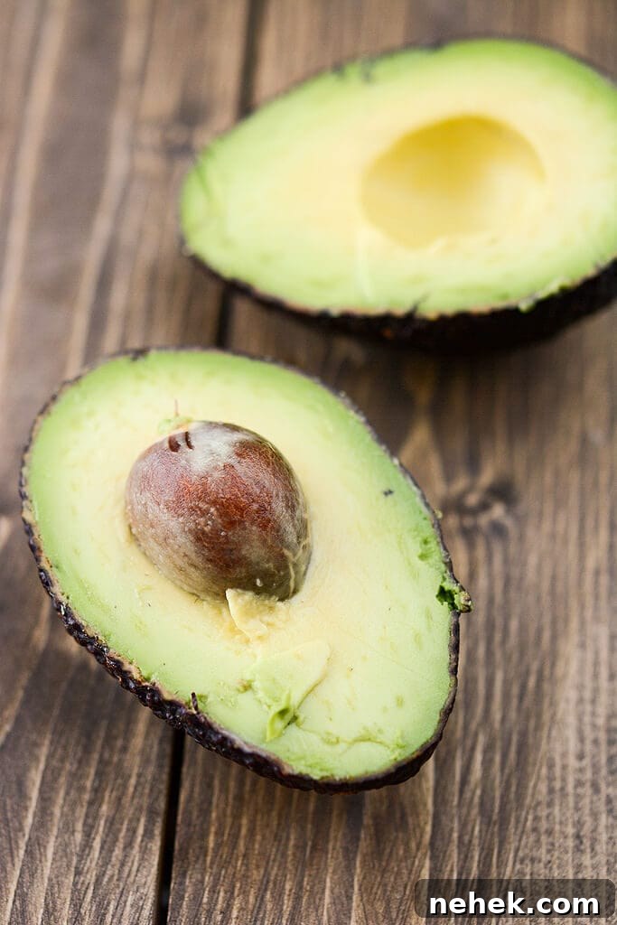 Avocado sliced in half - Grilled Corn Salad